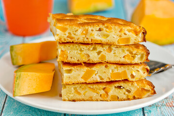 Pumpkin sponge cake baked in a pan, flat cake with pumpkin slices