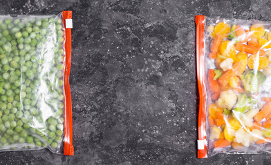 Frozen vegetables in zip packages on a dark table copy space