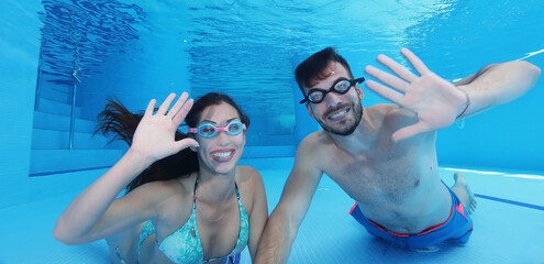 Young couple having a good time while diving