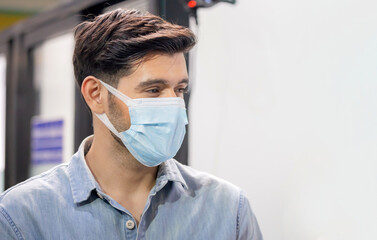 Cheerful young businessman wear protection face mask against coronavirus