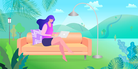 young woman lying on the grass she working on laptop