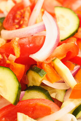 Vegetarian food. Salad of tomatoes, cucumbers, sweet peppers and onions drizzled with vegetable oil. Salad in a white plate.