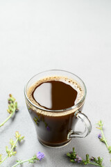 Alternative to coffee. Healthy drink chicory. Chicory coffee in a glass cup on a light gray table. space for text, vertical orientation.