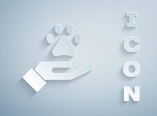 Paper cut Hands with animals footprint icon isolated on grey background. Pet paw in heart. Love to the animals. Paper art style. Vector.