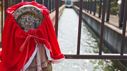 Jizo enshrined near a stream in a rural farming village in early summer in Nara, Japan, June 2, 2020.