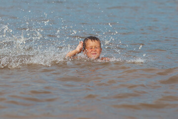 boy in the water with water splash 