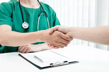 Male doctors and patients shook hands after the patients had finished their treatment. Medical concepts and good health