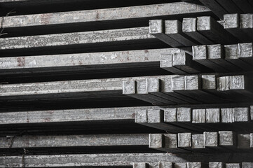 Steel billets in the warehouse of metallurgical factory. Hot ingot in a steel plant.