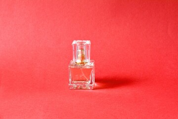 Perfume bottle on a red background.copy space.Natural spray.
