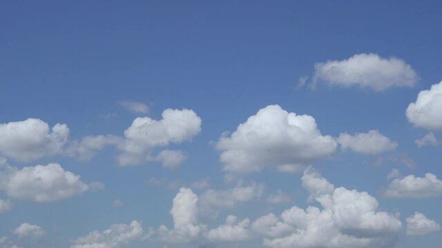 White Fluffy Clouds Float Across the Clear Blue Sky During the Day. Cloudy Weather. Pure Nitrogen Layer Of The Atmosphere. Clear Sunny Day.