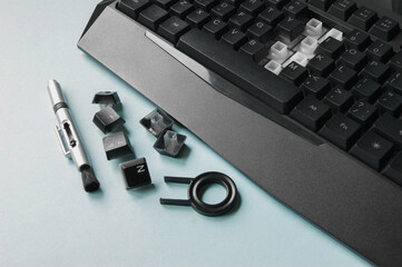 Keyboard, keys, brushes and key for replacing keys on a blue background.