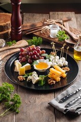 Wine appetizer platter with cheese and honey