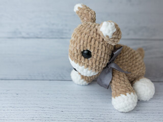 Plush dog on wooden background