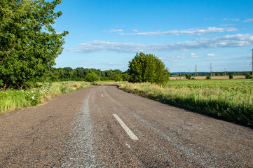 asphalt road goes into the horizon, blue sky with road