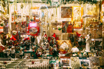Christmas window decoration with figures of gnomes and elves, toys, pendants, balls and pictures with lighting, for the new year. christmas toy store showcase.