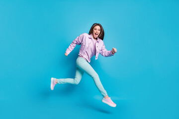 Fototapeta na wymiar Full length body size view of her she nice attractive pretty energetic motivated cheerful girl jumping running motion movement isolated on bright vivid shine vibrant blue color background