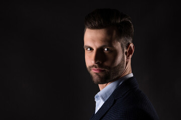 Fototapeta premium Close-up profile side view portrait of his he nice attractive content rich wealthy well-groomed agent broker guy corporate partner isolated over dark black color background