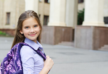Back to school. Education concept. Cute smiling schoolgirl on the way to the school.