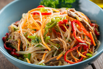 Funchoza noodle salad with stripes of vegetables