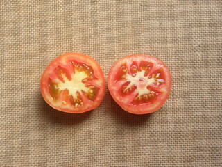 Cut halves of orange color fresh ripe tomato
