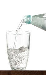 Pouring water into glass on table with isolated background