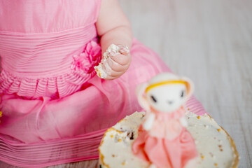 Crash pink cake at the celebration of the first birthday of the girl, ruined sponge cake, broken...