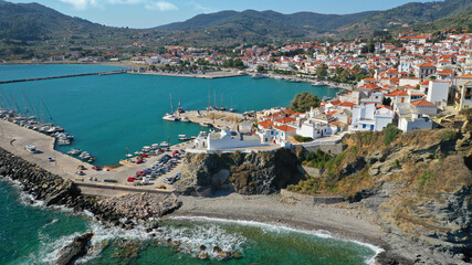 Fototapeta premium Aerial drone photo of beautiful main town and port of Skopelos island featuring landmark church of Virgin Mary and uphill venetian castle, Sporades islands, Greece