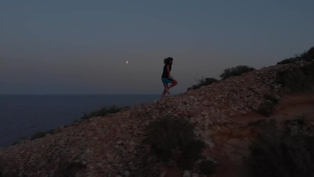 Sunset Trail Running with Moon in Background next to the Sea