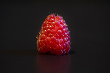 fresh raspberry on black background