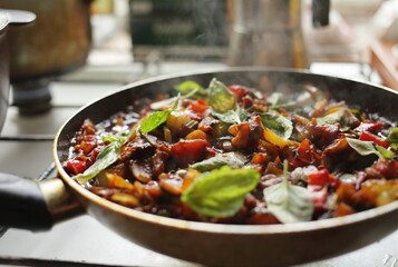 Healthy food vegetables are fried in a pan Tomato eggplant onion pepper zucchini