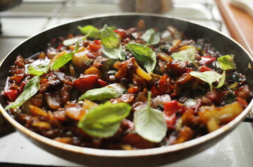Healthy food vegetables are fried in a pan Tomato eggplant onion pepper zucchini