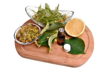 Fresh healthy linden flowers, lemon and essential oil