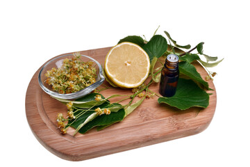Fresh healthy linden flowers, lemon and tea with essential oil on a white background