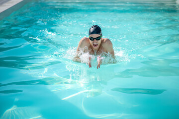 Fototapeta na wymiar Swimmer with open mouth in water in pool
