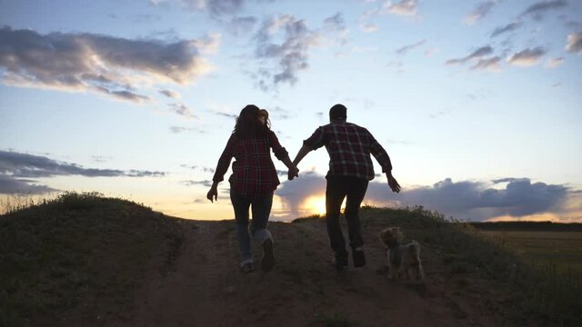 Teamwork. A happy family at sunset on the way to success. Healthy lifestyle, travel. Concept of freedom.