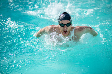 Fototapeta na wymiar Male swimmer with open mouth arms underwater