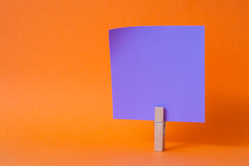 paper notes and clothespins isolated on orange background
