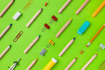 School supplies on green background. Back to school concept..