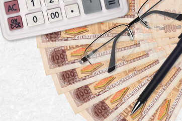 100 Guatemalan quetzales bills fan and calculator with glasses and pen. Business loan or tax...