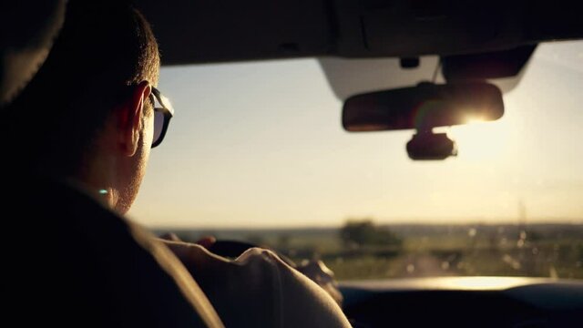 The man behind the wheel of his car. Human hands on the steering wheel. Ride along the city street in comfort.The concept of travel, business, and product delivery.