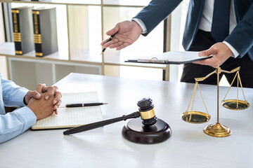 Male lawyer and businesswoman working and discussion having at law firm in office