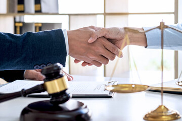 Businesswoman Shaking hands with lawyer after discussing good deal in courtroom