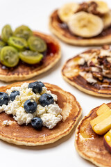 Healthy breakfast. Pancakes with fruit-berry and nut filling. White background.