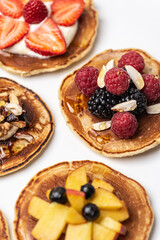 
Healthy breakfast. Pancakes with fruit, berry and nut filling on a white background.