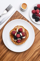 
Pancakes with strawberries and blueberries for breakfast. Top view.