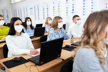 Students with safety masks attending the class and learning new stuff