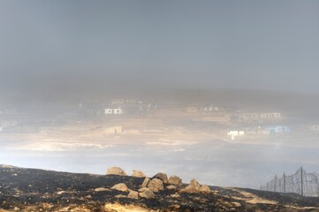 RURAL HUTS ON A MISTY HILLSIDE,  Ndawana, Kwazulu Natal, South Africa. 