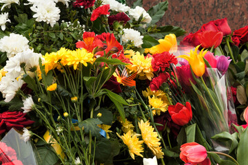 Flowers lie on the granite slab monument to soldiers