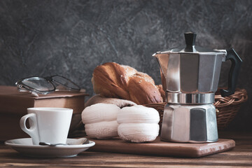 Coffee with marshmallow or zephyr sweet cake. Food composition on table in rustic style.