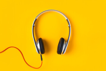 White headphones isolated on yellow background